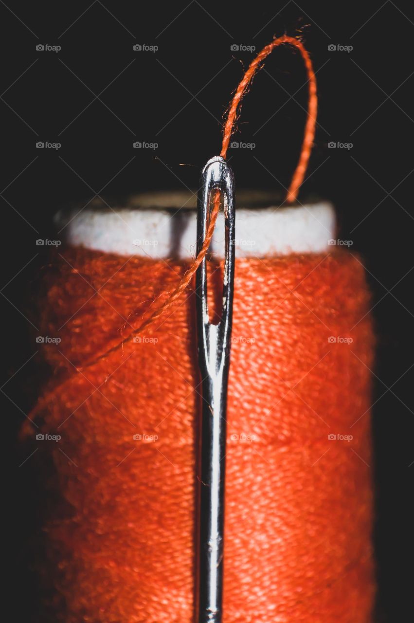 Macro shot of needle and thread.