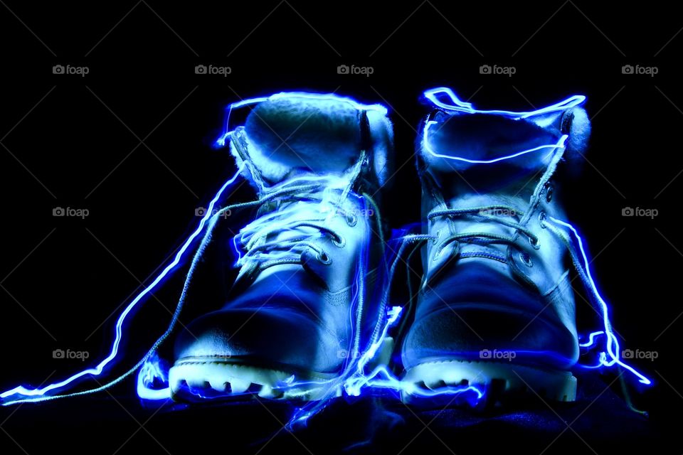 Artificial light, boots outlines with penlight covered in blue, abstract 