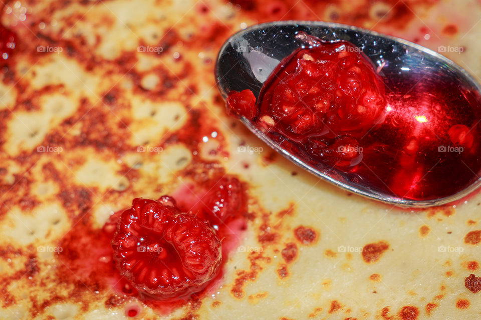 Close up of delicious raspberry jam on a pancake