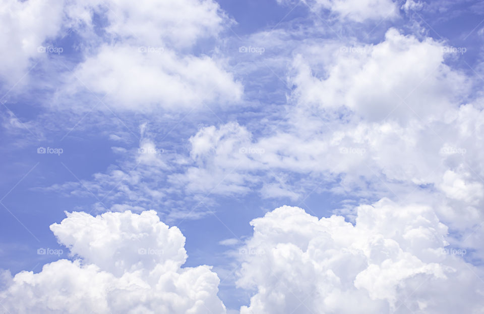 The beauty of the sky with clouds and the sun in summer.