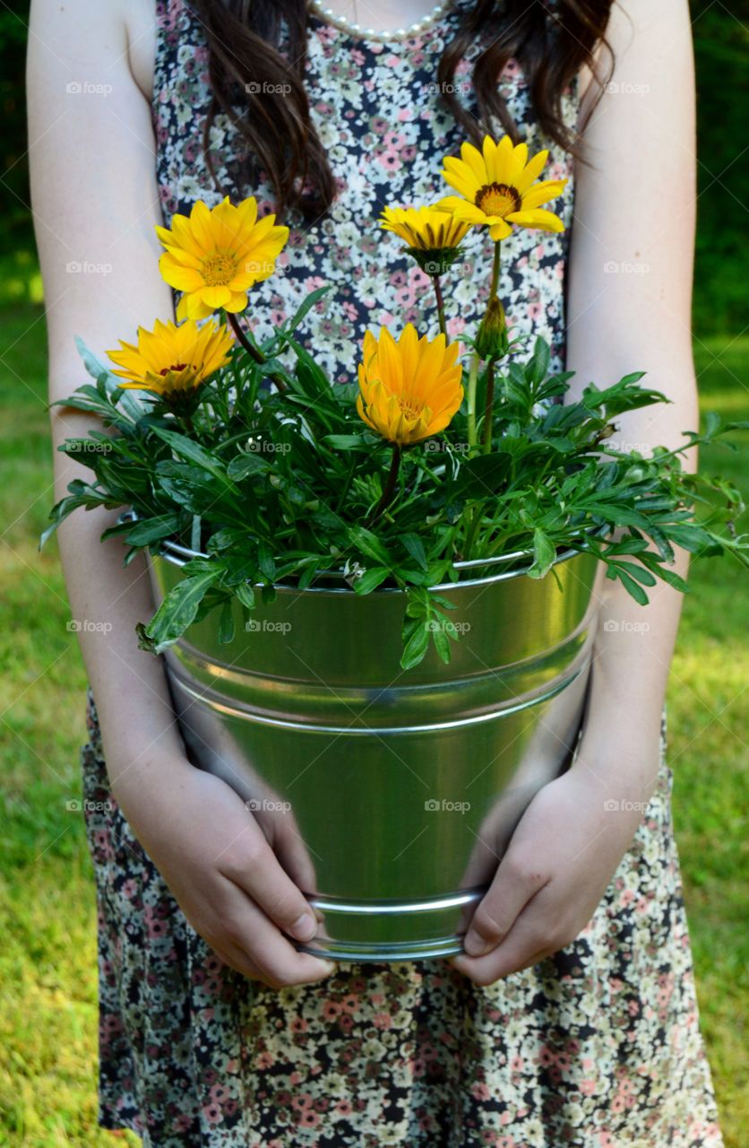 A woman holding potted plant