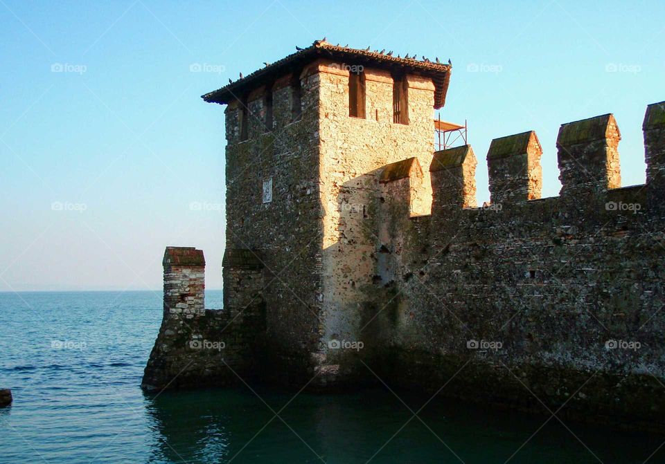 A castle wall by the lake