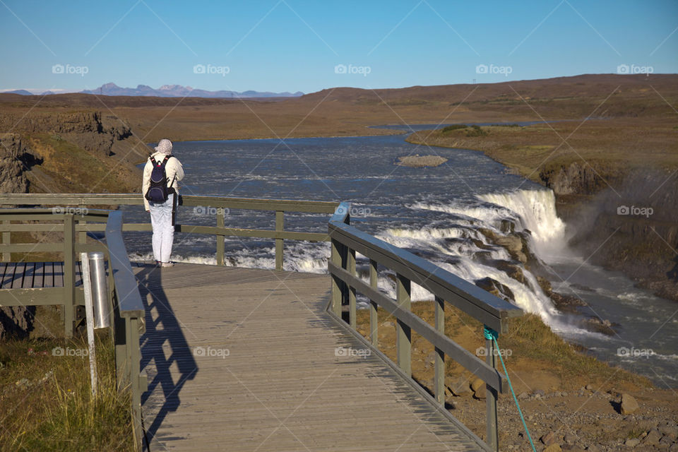 Woman looking at Gullfoss on Iceland.