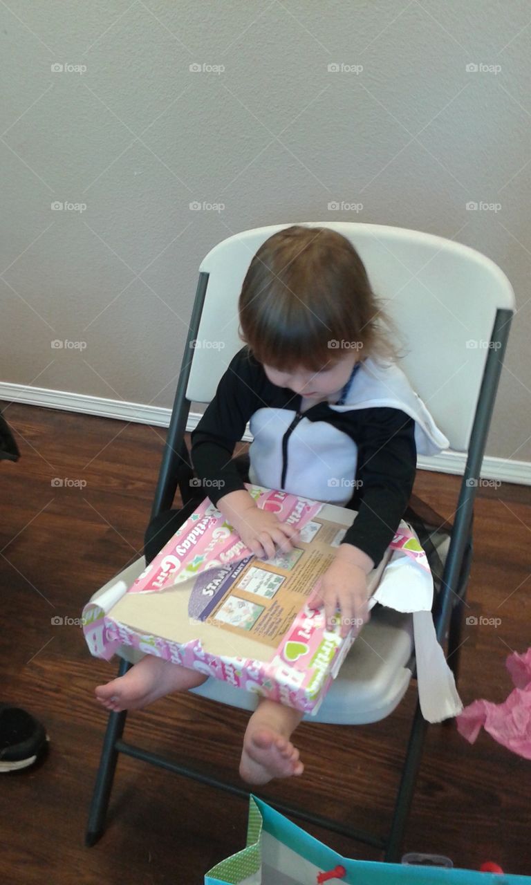 opening her second birthday presents