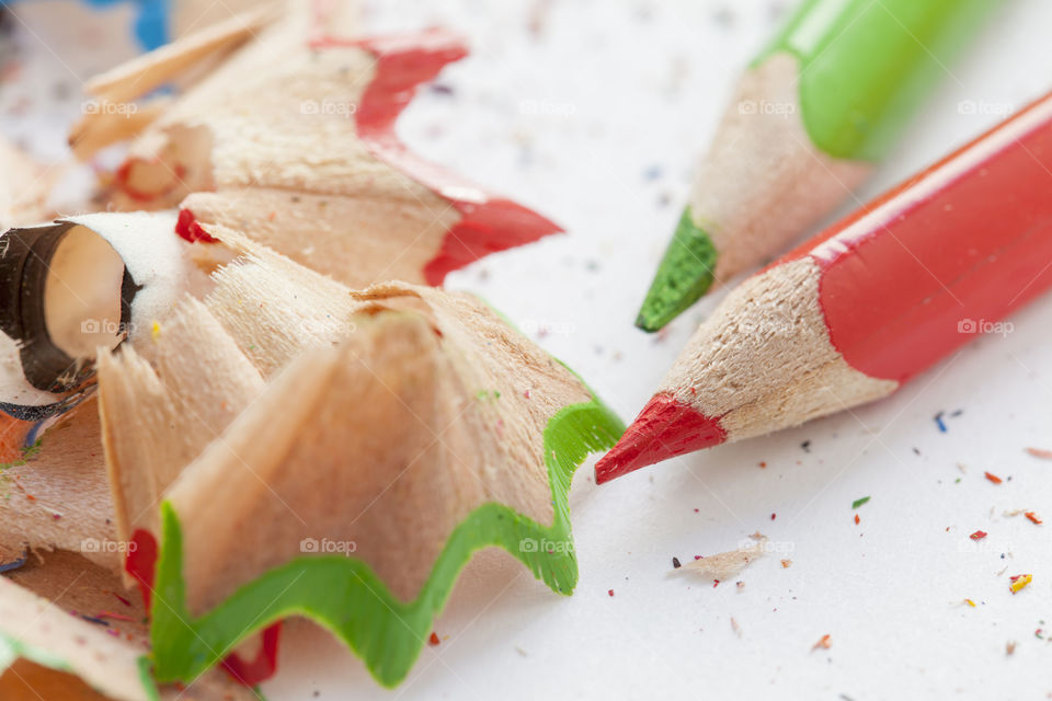 Close-up of colored pencils and shavings