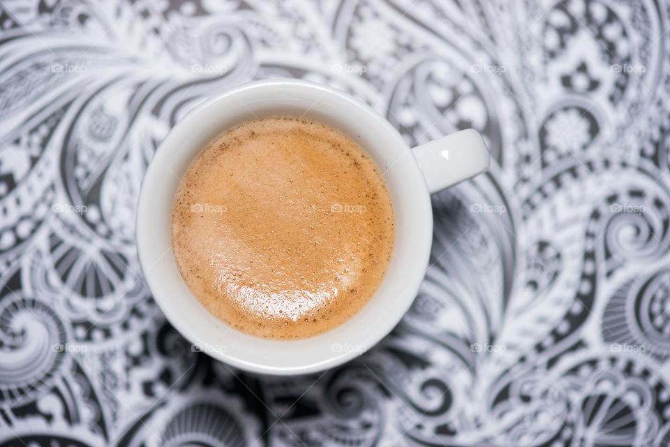 coffe cup against a patterned background