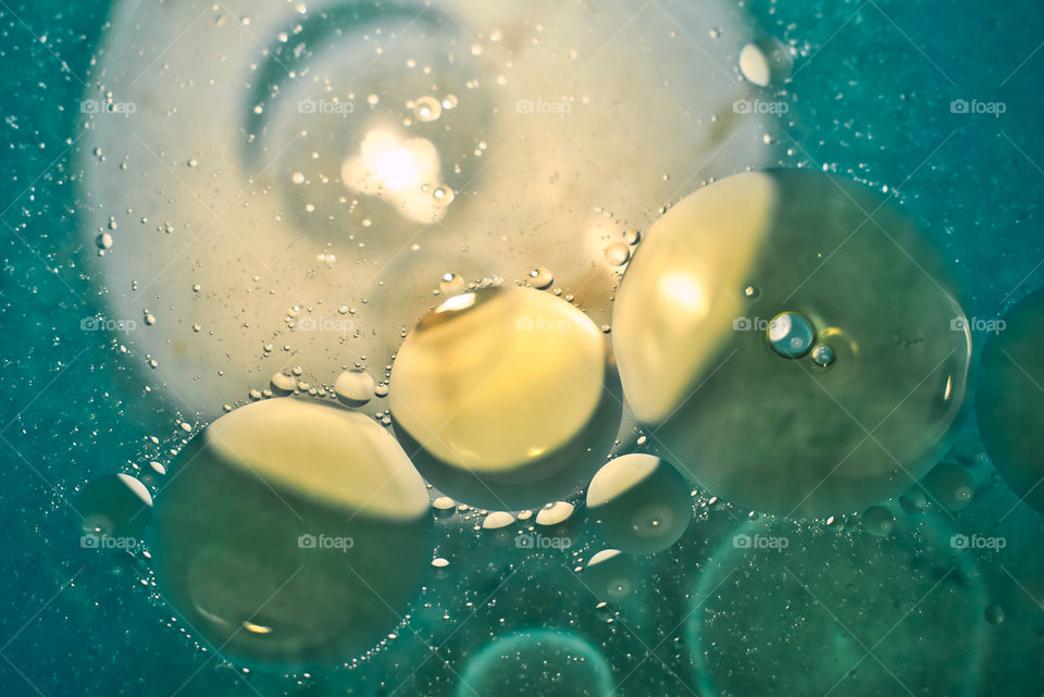 Green oil bubbles on the water surface