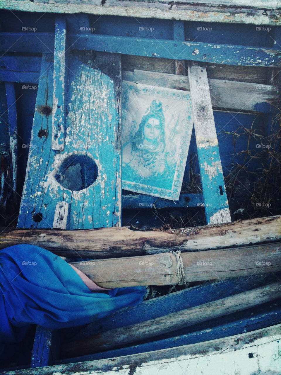 Faded Indian poster in a weathered blue boat