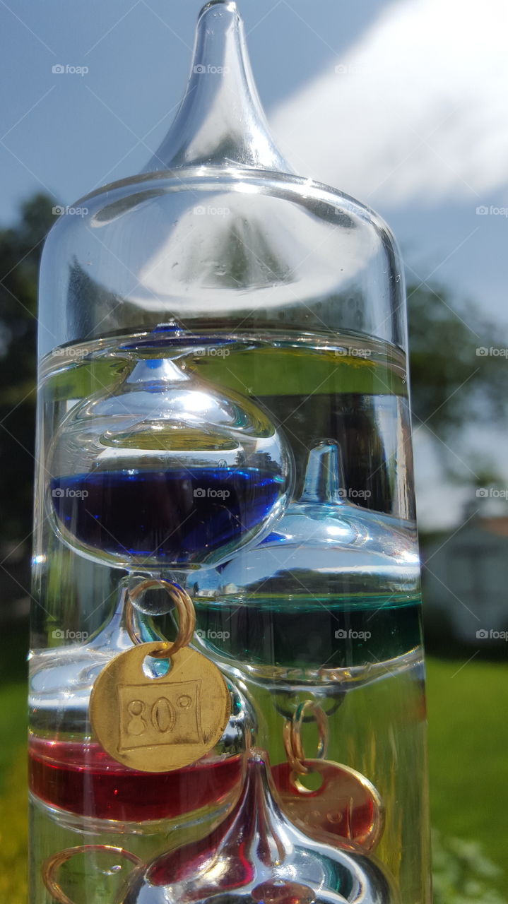 Galileo thermometer. close up of blown glass thermometer