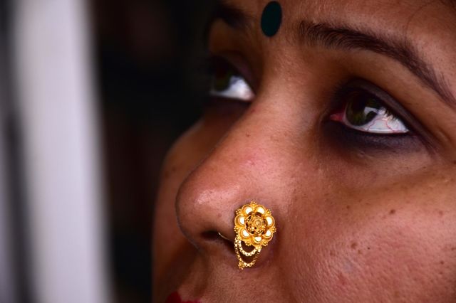 Indian woman wearing gold nose pin