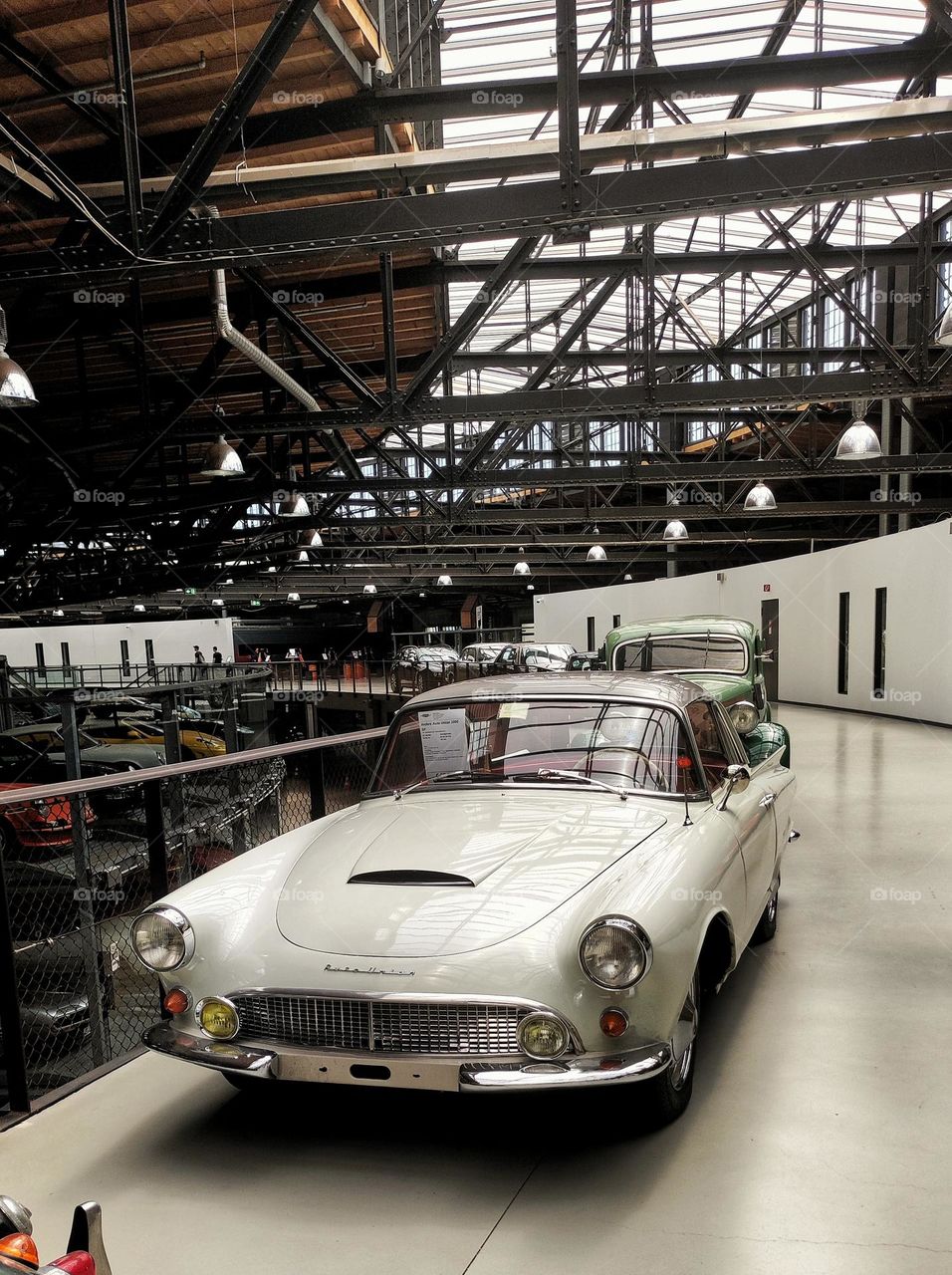 A stunning retro Audi from the 20th century in white colour in a building, white walls, floor and car/ Old building with beautiful vintage cars