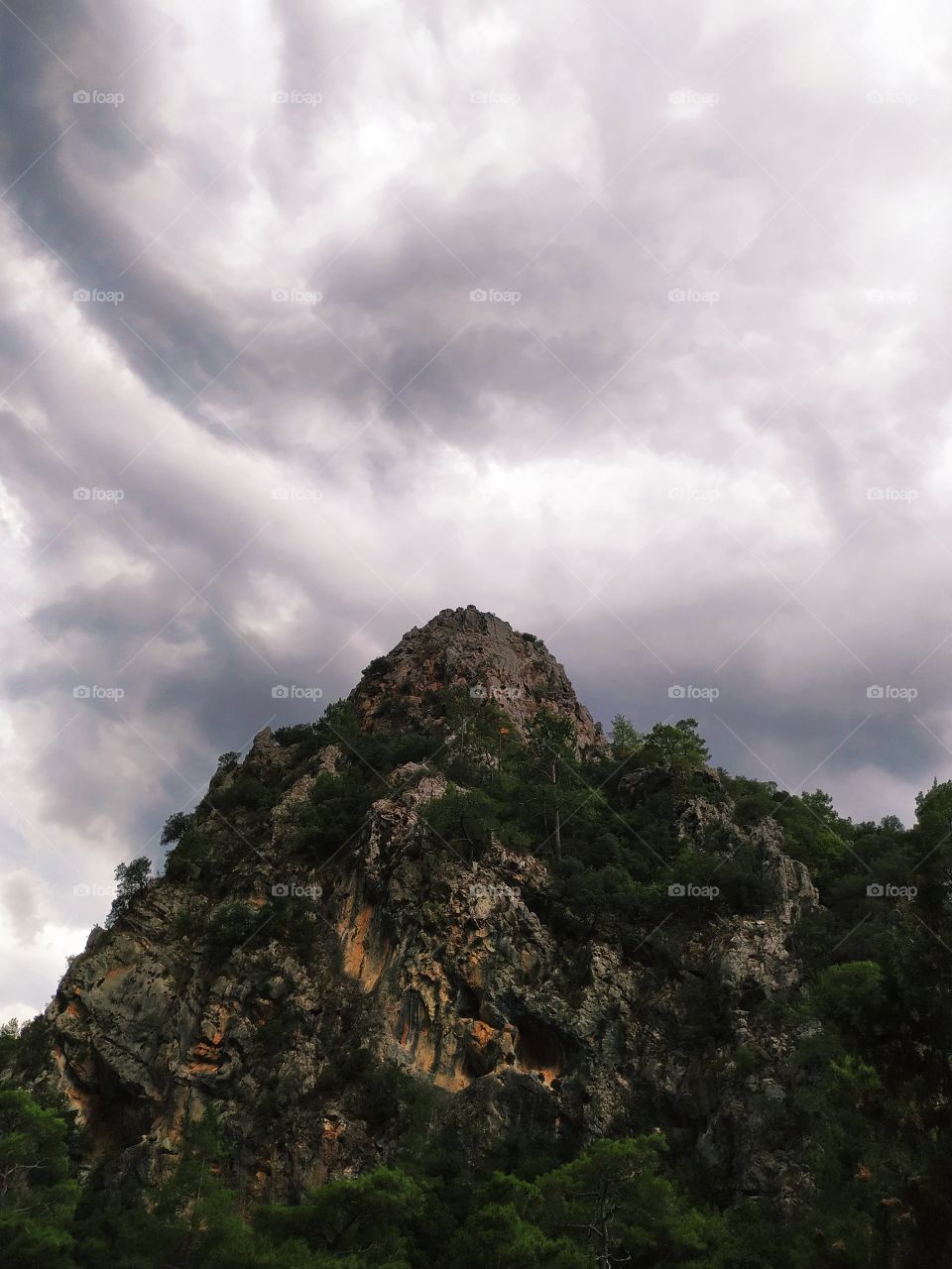 A beautiful dark mountain with nature view with scary pre-storm sky and clouds.