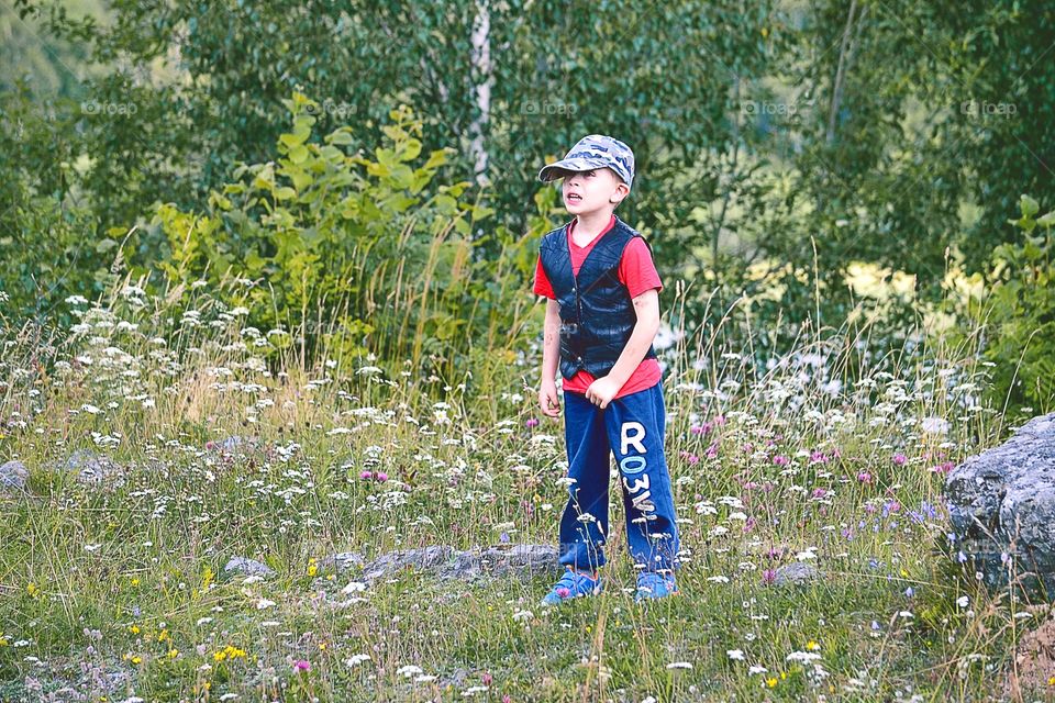 Boy among summerflowers