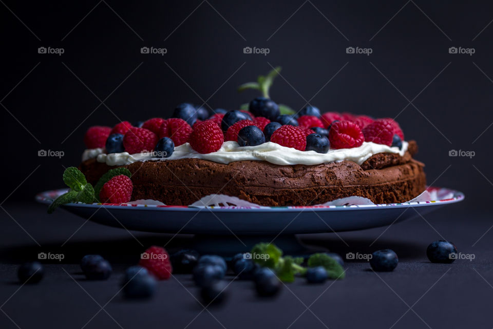 Berry cake against black background