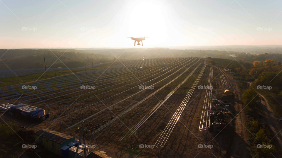 Drone make photo of building solar power station. Sunset 