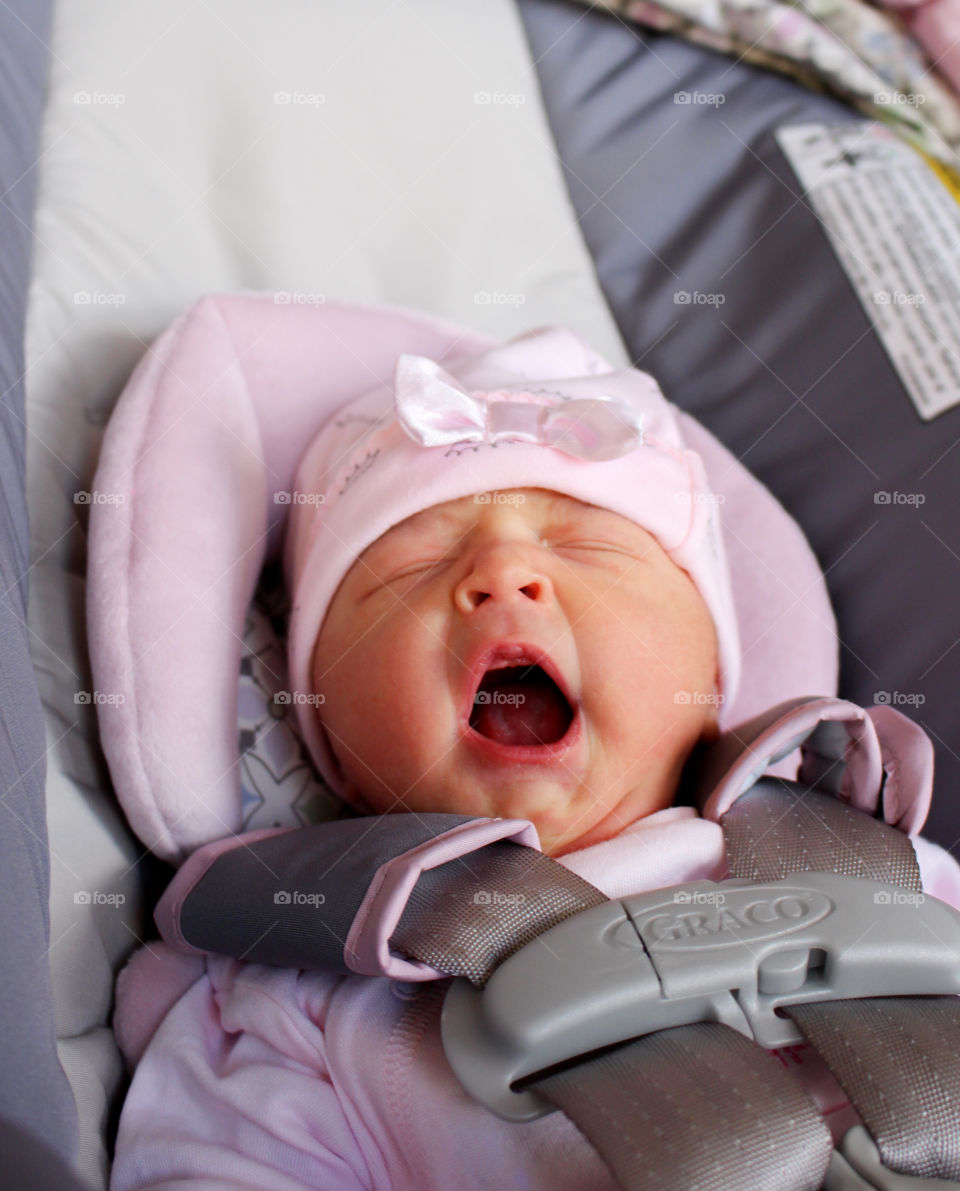 Cute baby yawing in baby carriage