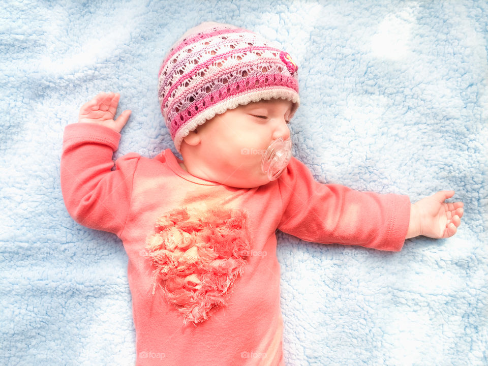 My heart beating. Little baby girl sleeping on blue blanket