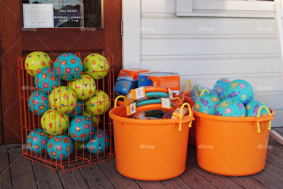 Balls and buckets in front of a store