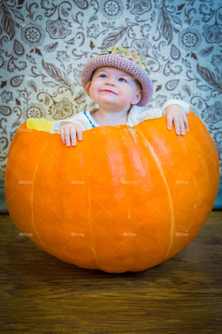 Baby inside large pumpkin