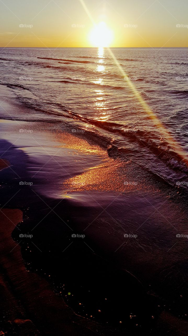 Light reflections on the beach at dusk.