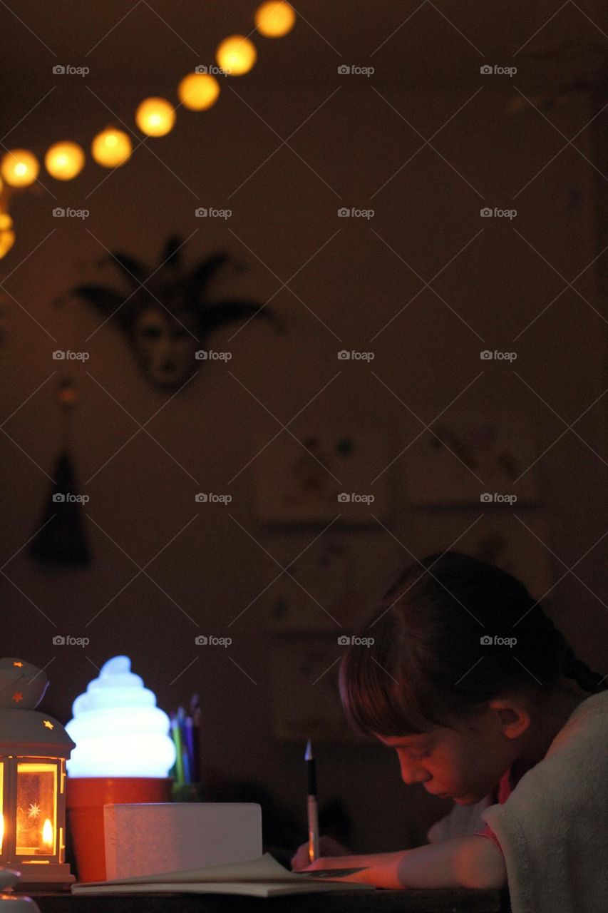 Girl draws with a simple pencil