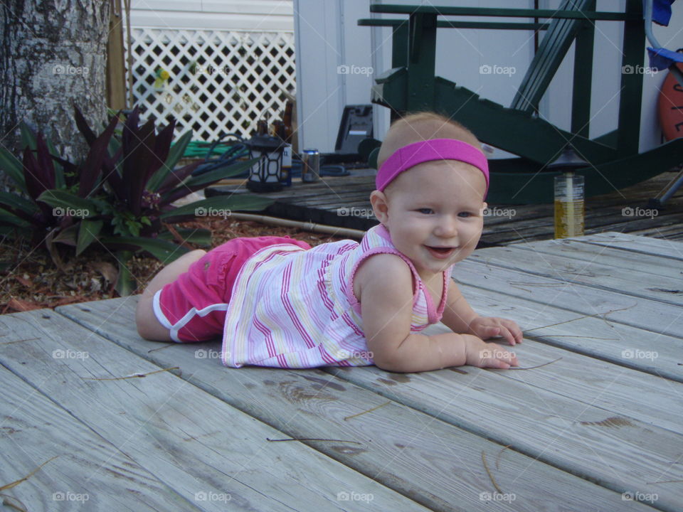 Cute baby girl on wood