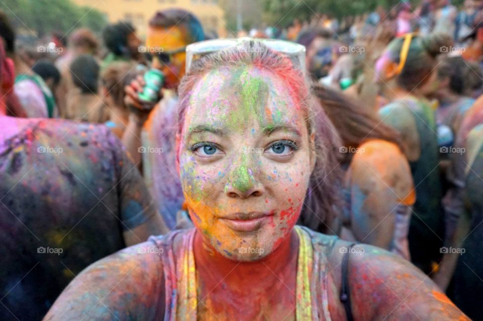 Vivid colors splashed onto my face during a Holi celebration in Madrid, Spain 