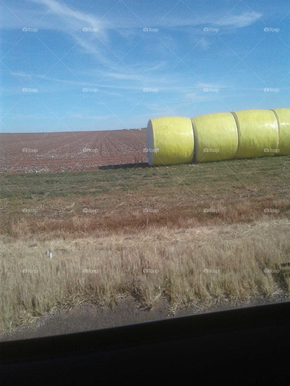 Altus Oklahoma bail of Cotton in field Red dirt