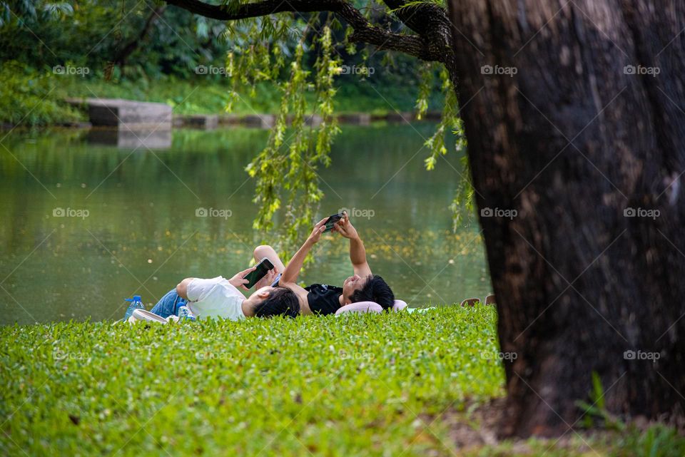 The couple is relaxing while playing their phones