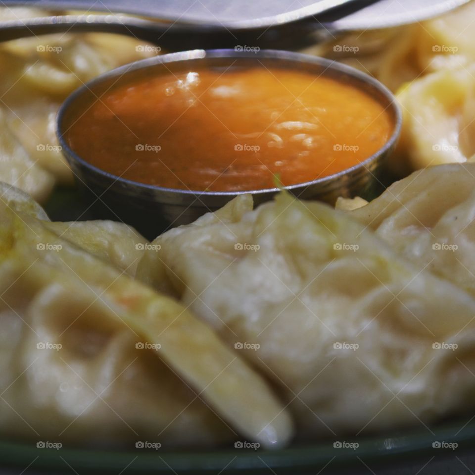 momo dumplings served with sauce in nepal