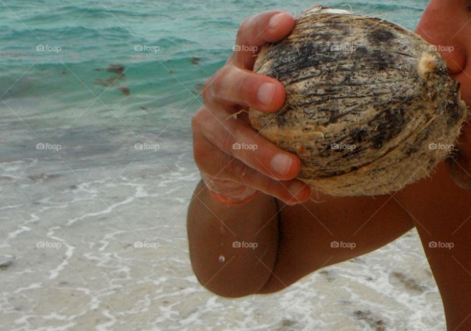 Man drinking coconut water at beach