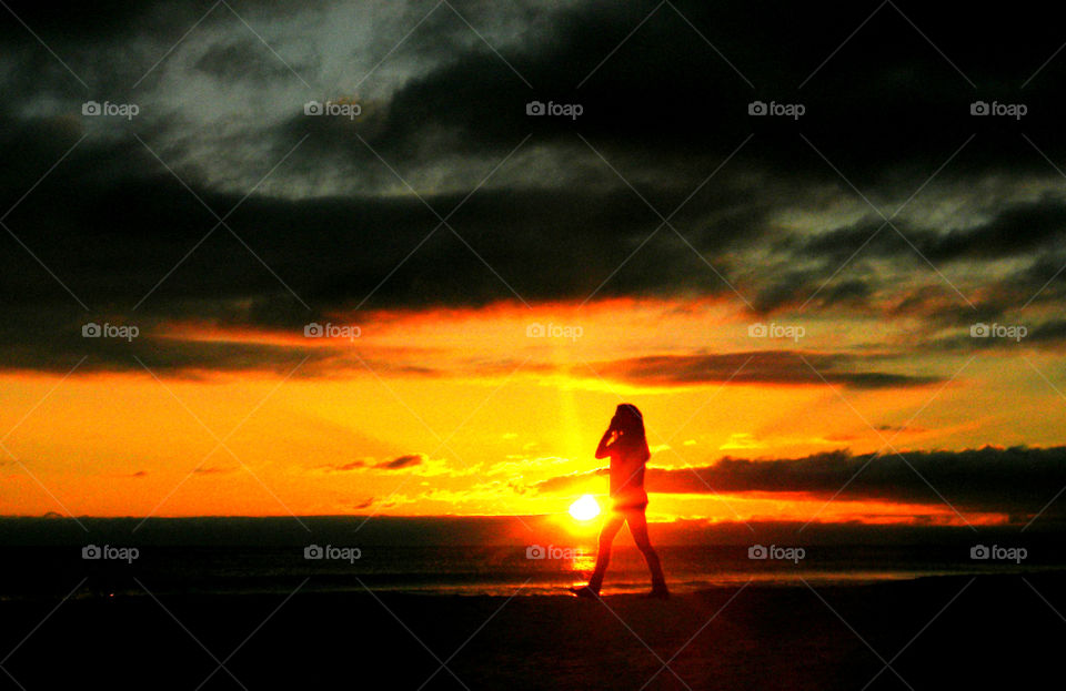 An amazing silhouette of a woman at the beach