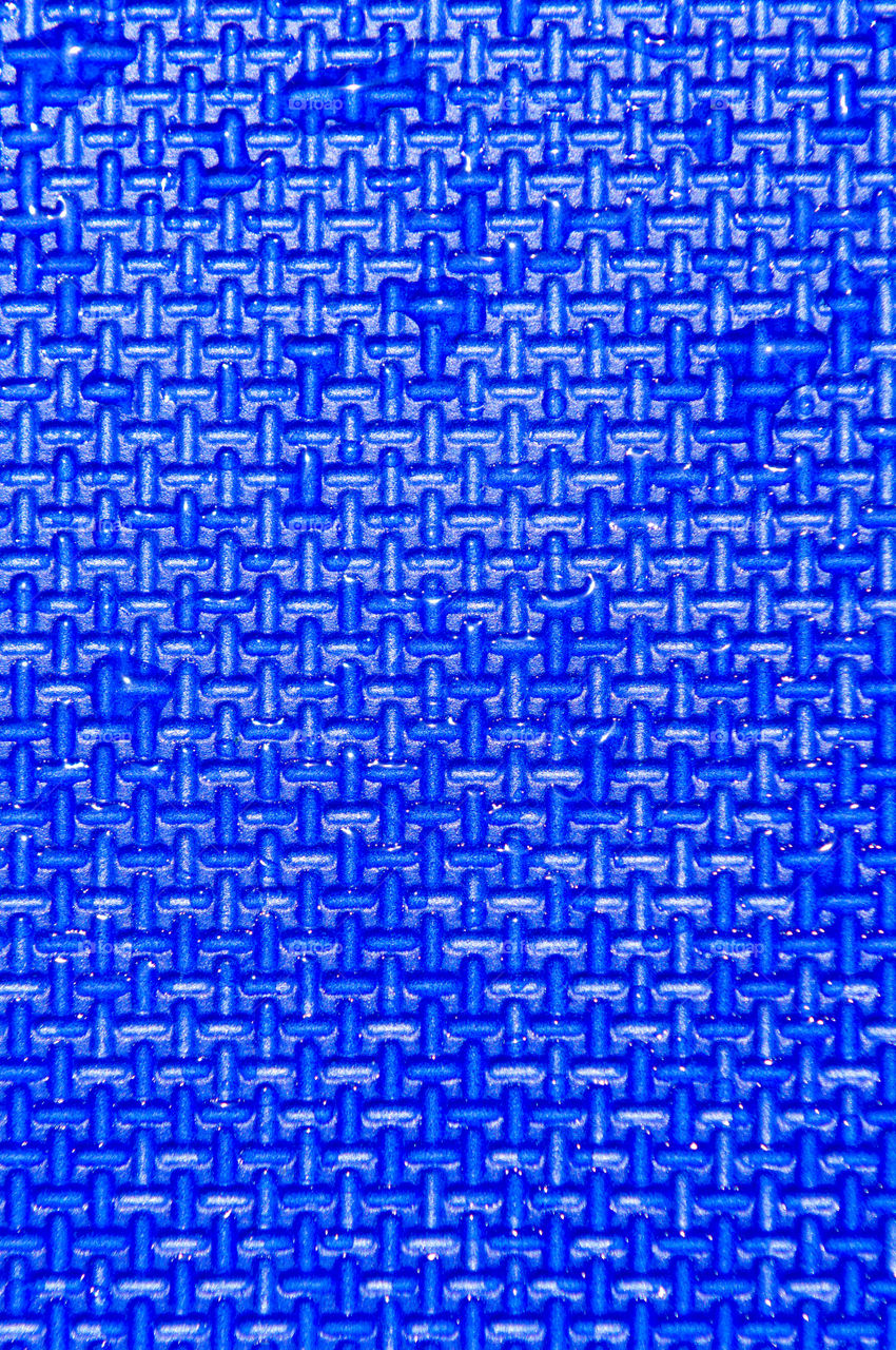 Textured, blue crosshatch pattern with water droplets