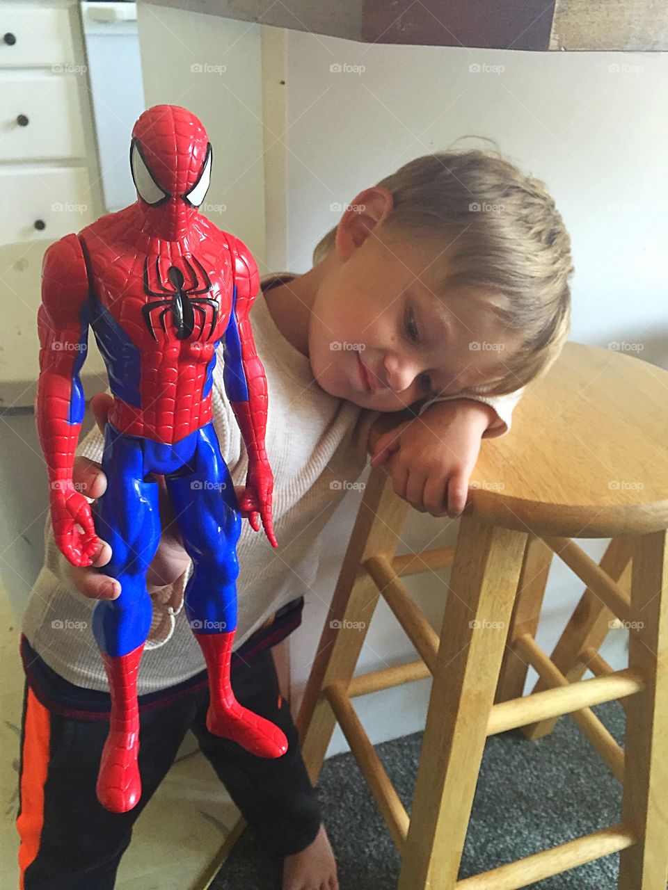 Small boy holding Spiderman toy