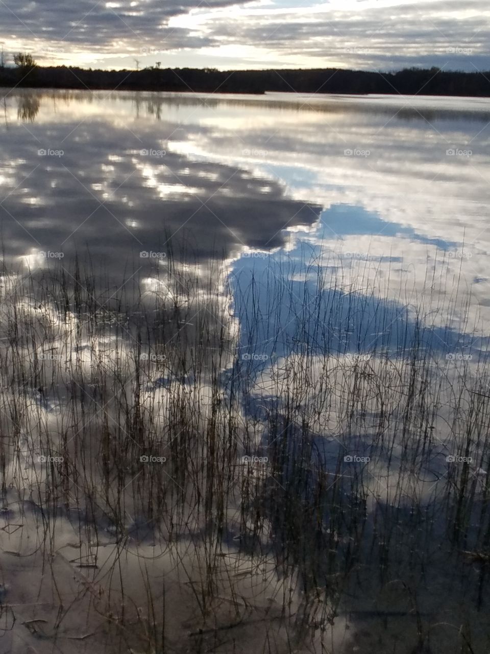 mirroring clouds on a lake