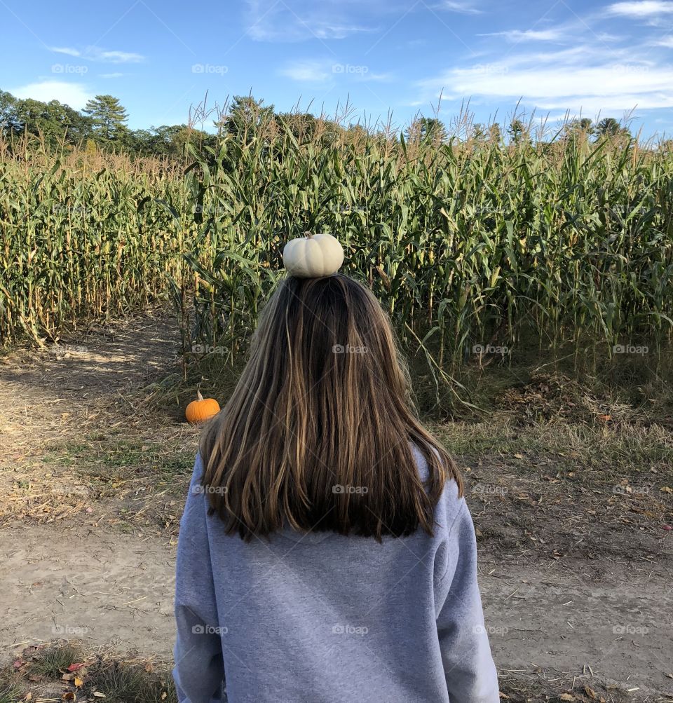 Girl with pumpkin on head