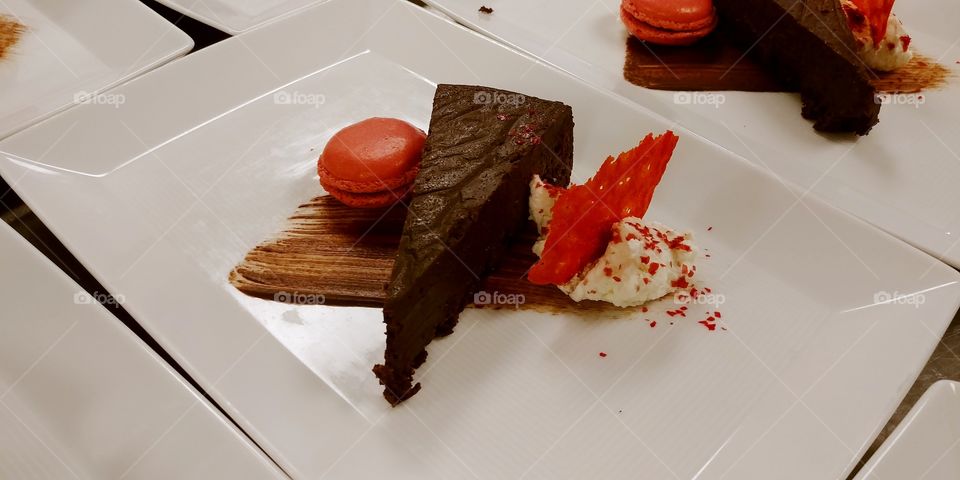 chocolate torte with raspberry macaroon, fried tuile and whipped cream