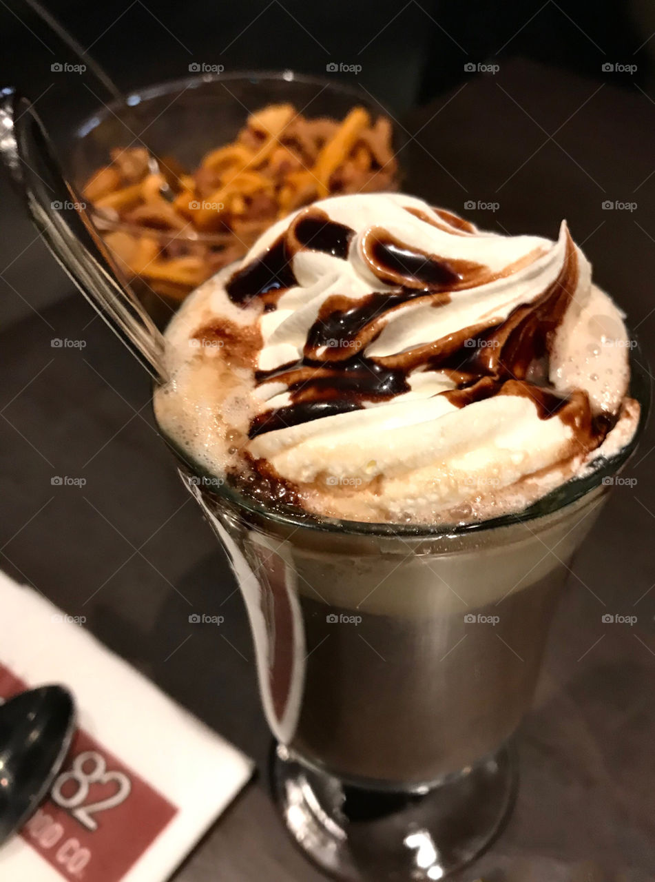 Mochaccino with whipped cream and chocolate syrup