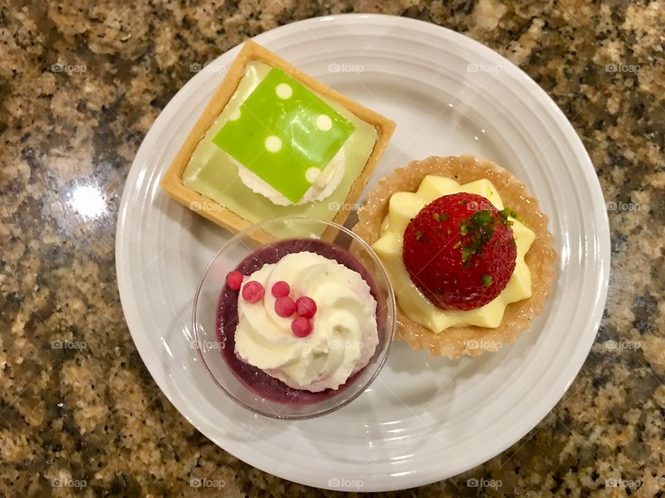 Dessert plate with pastries and cheesecake parfait