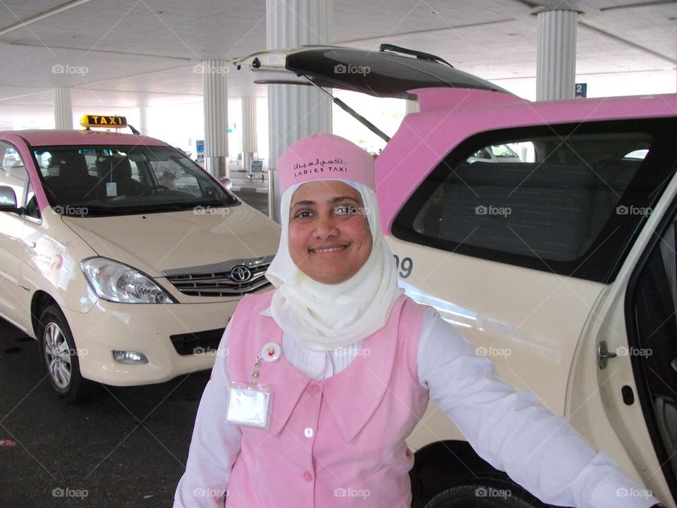 Service with a smile , women taxi driver in Dubai 