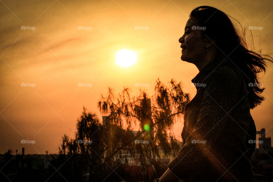 woman looks at sunset