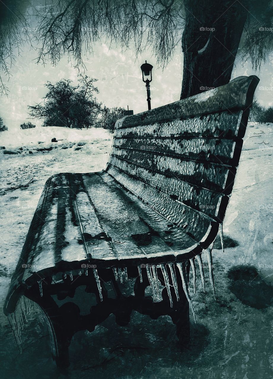 Old bench covered with icicles