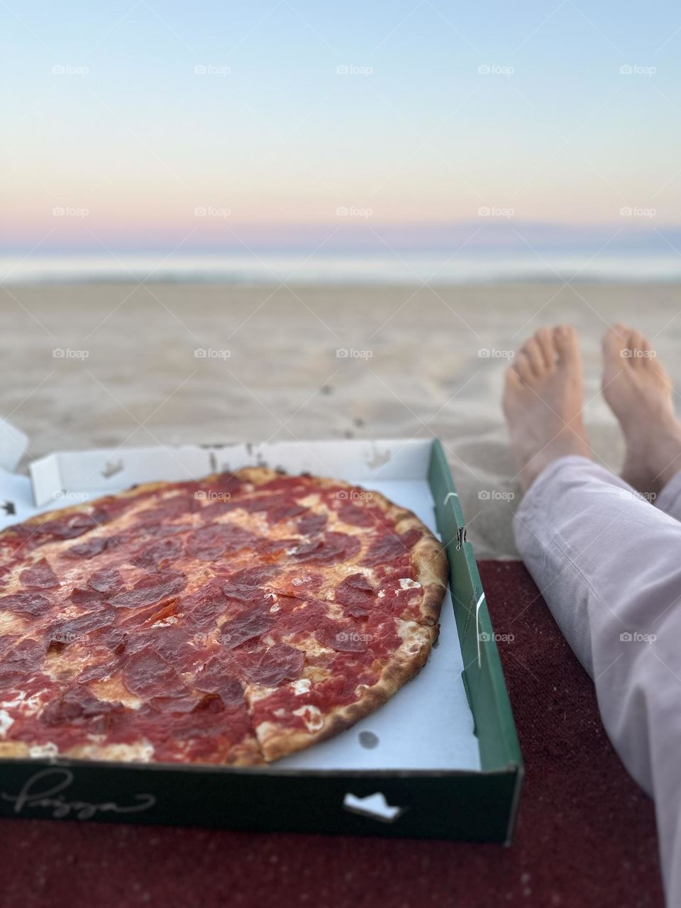 Eating pizza at the beach, relaxing on the beach with pizza, eating pizza outside, beaches and pizza, delicious snacks at the beach 