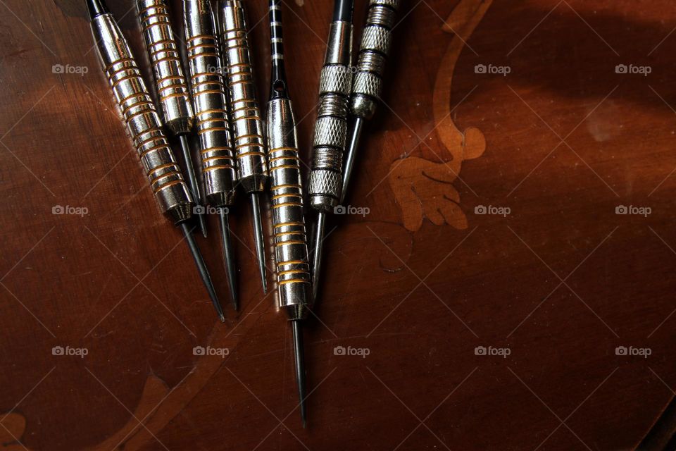 Close-up of darts lying on a table
