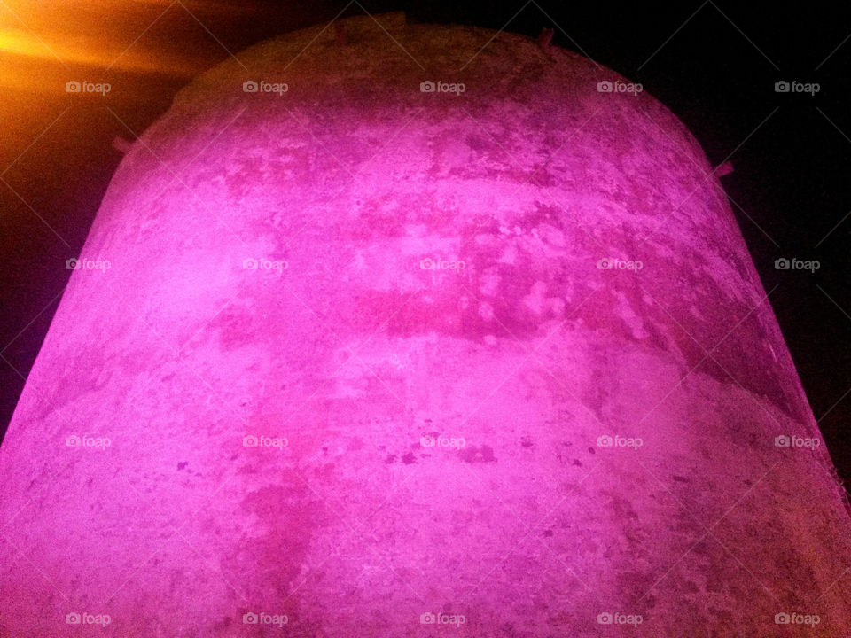 old fortified tower illuminated by pink light - Sardinia