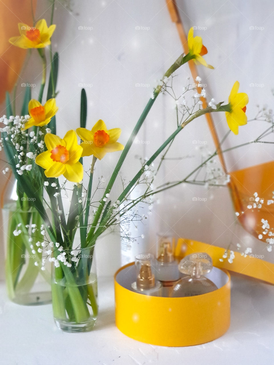 Spring mood.  A bouquet of spring flowers with women's accessories: a handbag, stole, creams and perfumes in a gift box