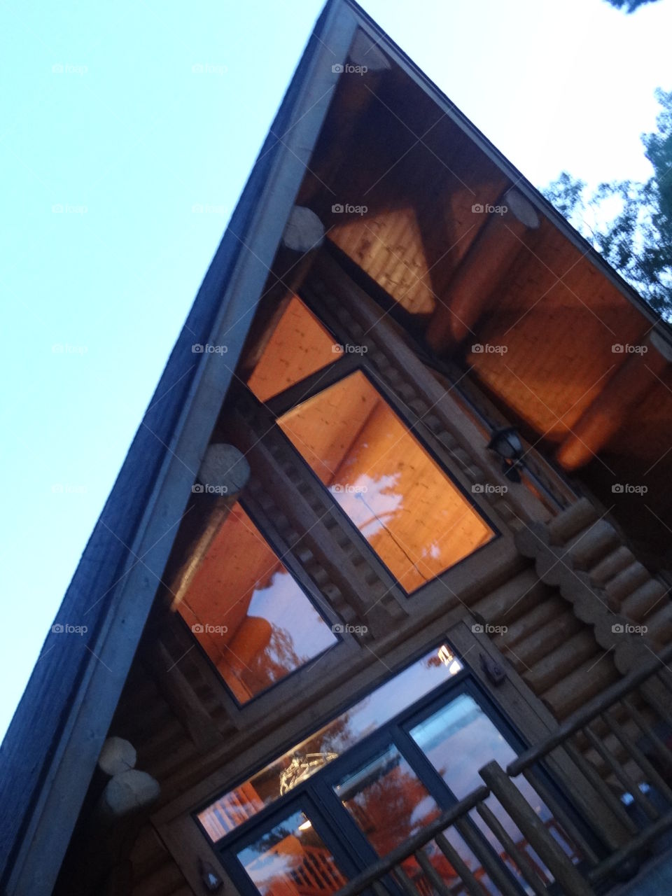 Log home from below. Log home on Lake Huron lit up at night
