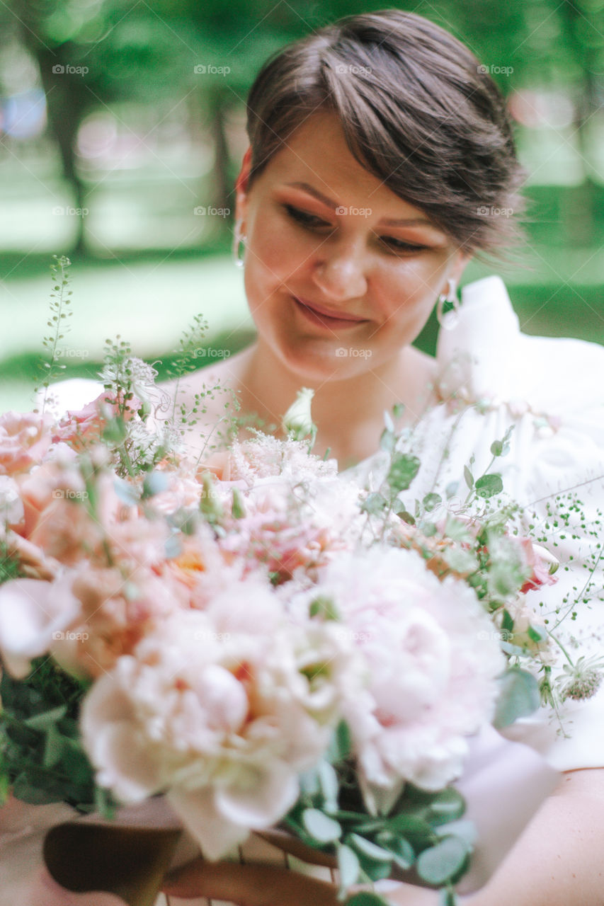 beautiful woman admiring her flowers