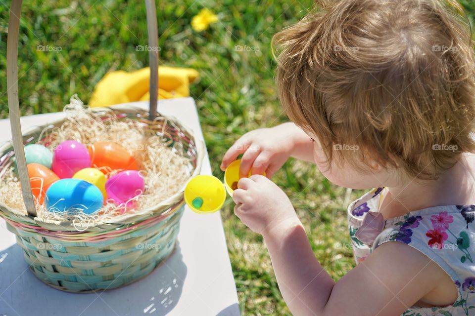 Young Girl Finding Treats In Easter Basket