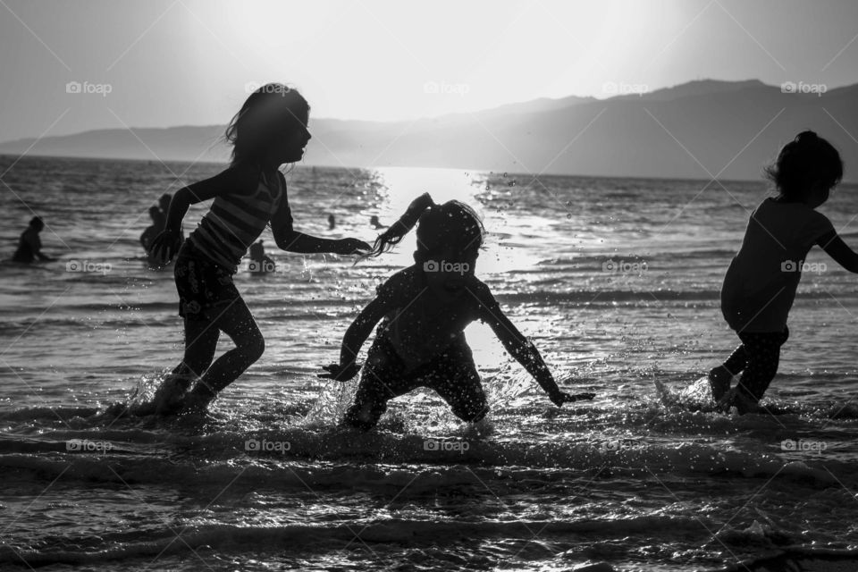 Kids playing in the ocean